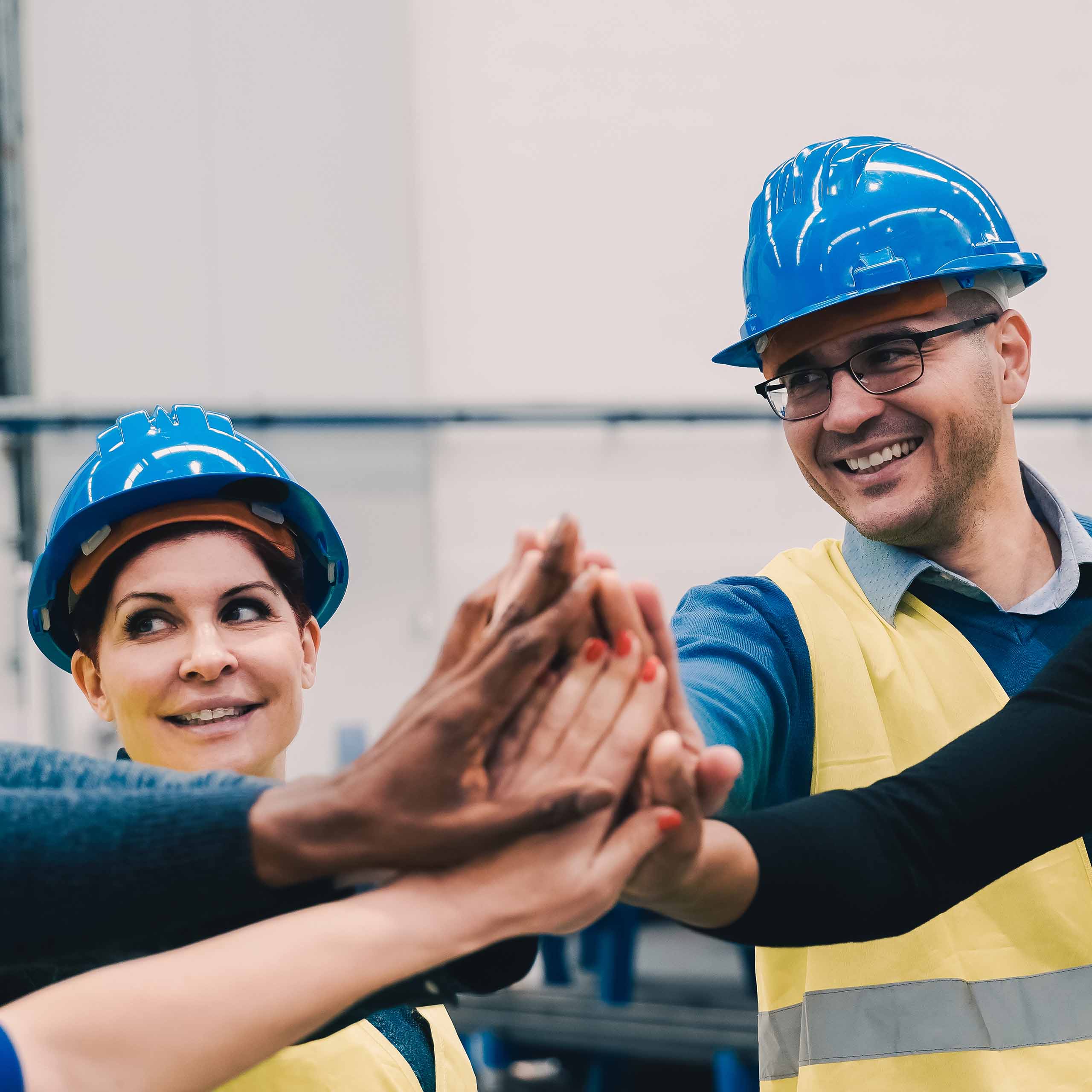 engineers putting hands together after a success